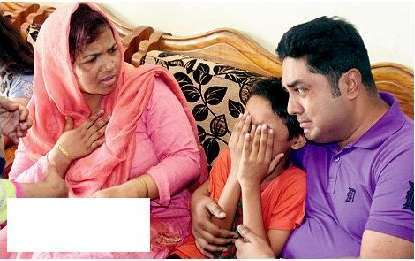 TRAGEDY: Mahmuda Aktar’s young son (centre) grieves with other family members